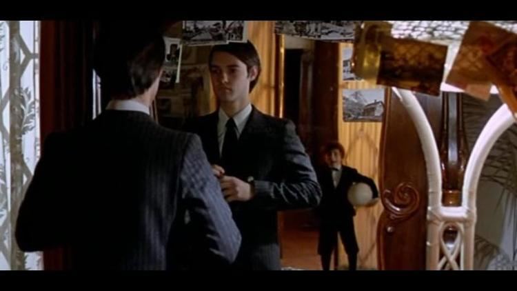 Alessandro Momo while wearing his tuxedo in front of a mirror in a movie scene from Malicious (1973 film)