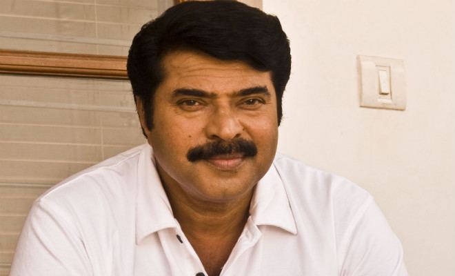 Mammootty smiling while wearing a white polo