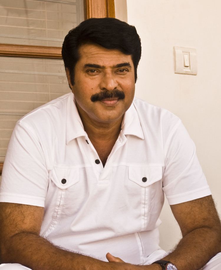 Mammootty smiling while wearing a white polo