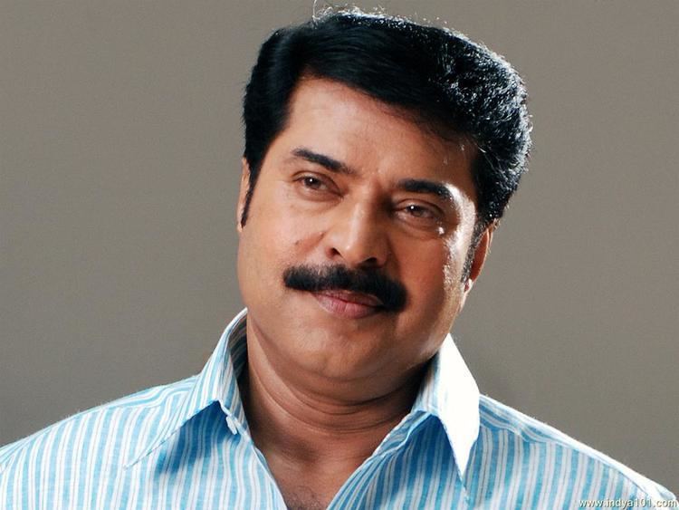 Mammootty smiling while wearing a blue striped long sleeves