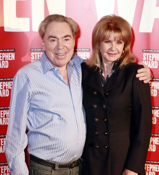 Mandy Rice-Davies posing at an event with her husband, businessman Ken Foreman wearing black blouse, pants and sandals.