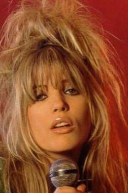 Mandy Smith singing while holding a microphone with a messy hair