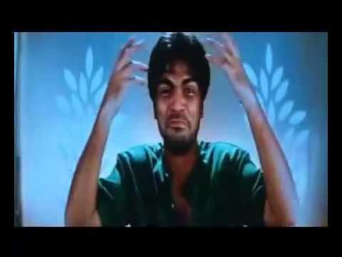 Silambarasan is crying while wearing a green t-shirt in a scene from the 2004 Tamil crime thriller film, Manmadhan