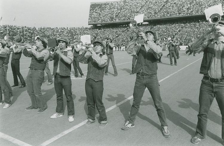 Marching Owl Band Marching Owl Band MOB horn section on football field with denim caps