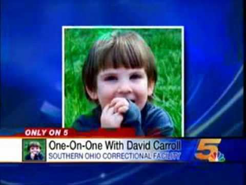 In Only on 5 news with blue background, in the middle is Marcus Fiesel is happy, in the middle of the grass, with both hands closed together over his mouth, has brown hair, wearing a blue denim long sleeve. below is a word written "only on 5" "One-on-One With David Caroll Southern ohio Correctional Facility"