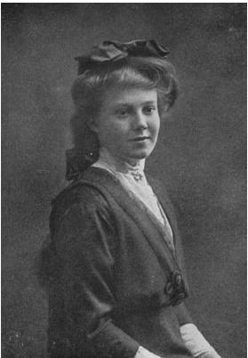 Margaret Carnegie Miller's tight-lipped smile while wearing a long sleeve dress and a ribbon on her hair