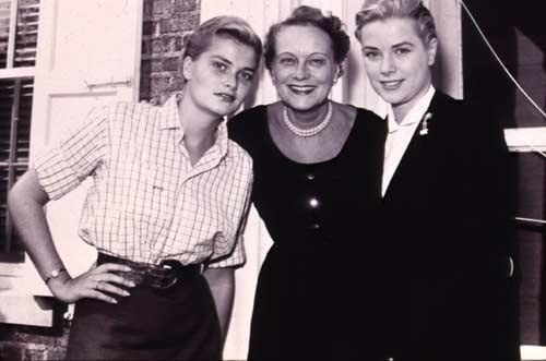 Margaret Katherine Majer smiling in the center in a black dress with her two daughters Grace Kelly in a checkered shirt and Lizanne in a black coat