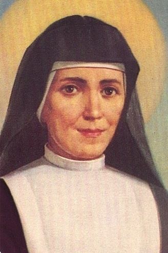 Maria Domenica Mazzarello is smiling wearing a white head cover under a black nun veil and a religious nun habit clothing