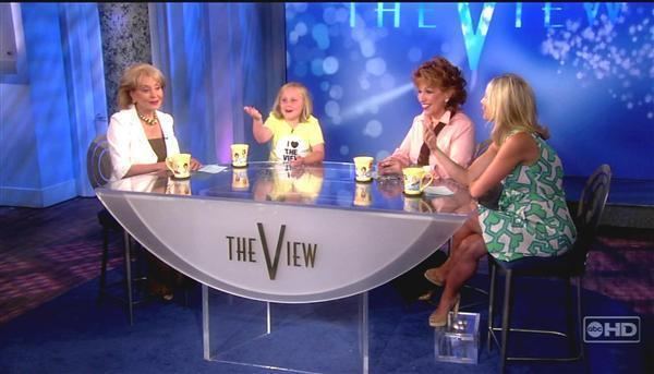 Maria Lark in her interview wearing a yellow printed shirt with three other women sitting on a table | The View