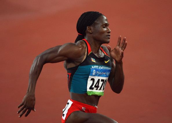Maria Mutola, during her track and field competition, while wearing a black and red top and red shorts