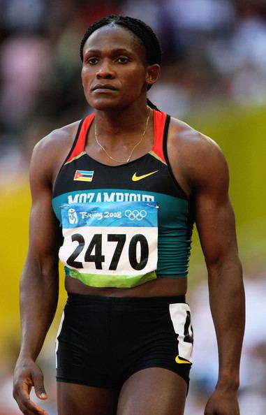 Maria Mutola, during her track and field competition, while wearing a black and orange top and black shorts