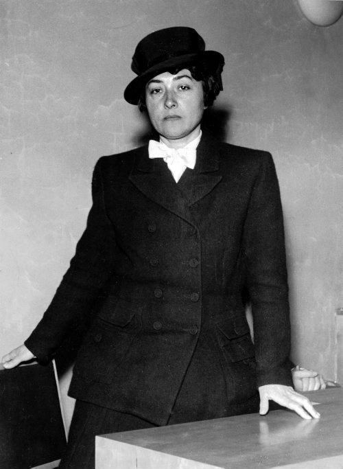 Maria Quisling wearing a white shirt with ribbon and a suit (a black and white photo)