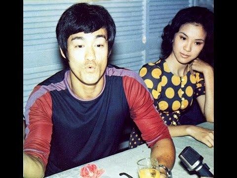 Maria Yi wearing black and yellow polka dots dress and Bruce Lee wearing a long sleeves shirt