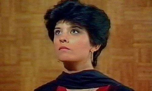 Marina Khan with short hair and wearing a black and red blouse
