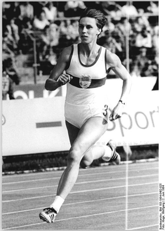 Marita Koch running while wearing a bodysuit and rubber shoes
