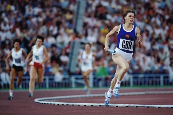 Marita Koch during her track and field competition and wearing a blue top and white shorts