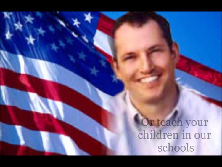 On the left is the flag of the United States of America while, on the right, Mark Bingham smiling and wearing a white polo shirt