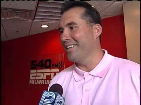 Mark Chmura wearing pink polo shirt in one of his interviews