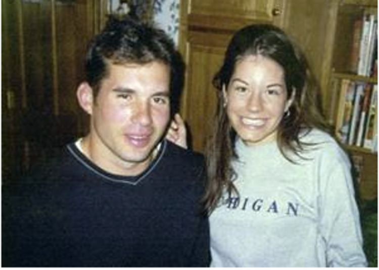 Young Mark Chmura wearing black t-shirt and a woman beside him wearing gray long sleeves