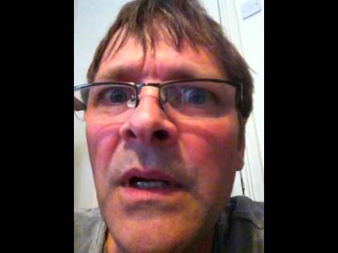 Mark Heap wearing eyeglasses and a gray shirt.