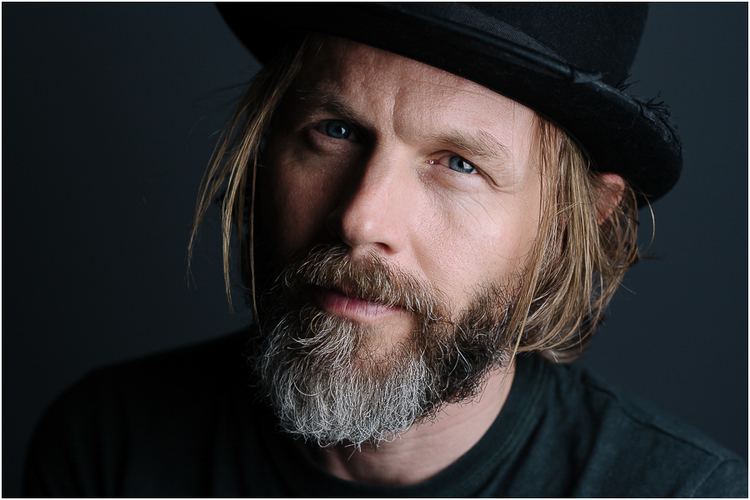 Mark Letheren wearing a black hat and black shirt.