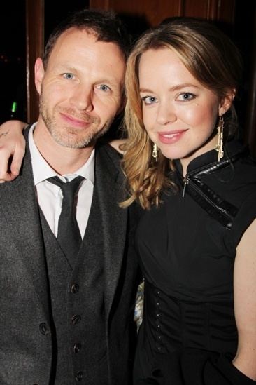 Mark Letheren wearing a black suit and a tie with Georgia Taylor wearing a black dress and earrings.