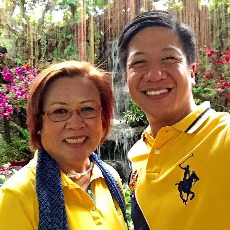Mark Leviste wearing a yellow polo shirt and Leila de Lima wearing a yellow polo shirt with blue scarf