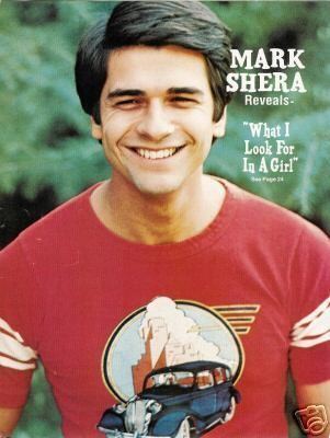 Poster of Mark Shera wearing a red shirt with a car.