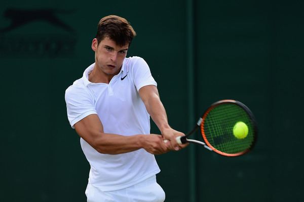 Marko Osmakcic playing tennis against Yunseong Chung of Korea during day six of the Wimbledon Lawn Tennis Championships