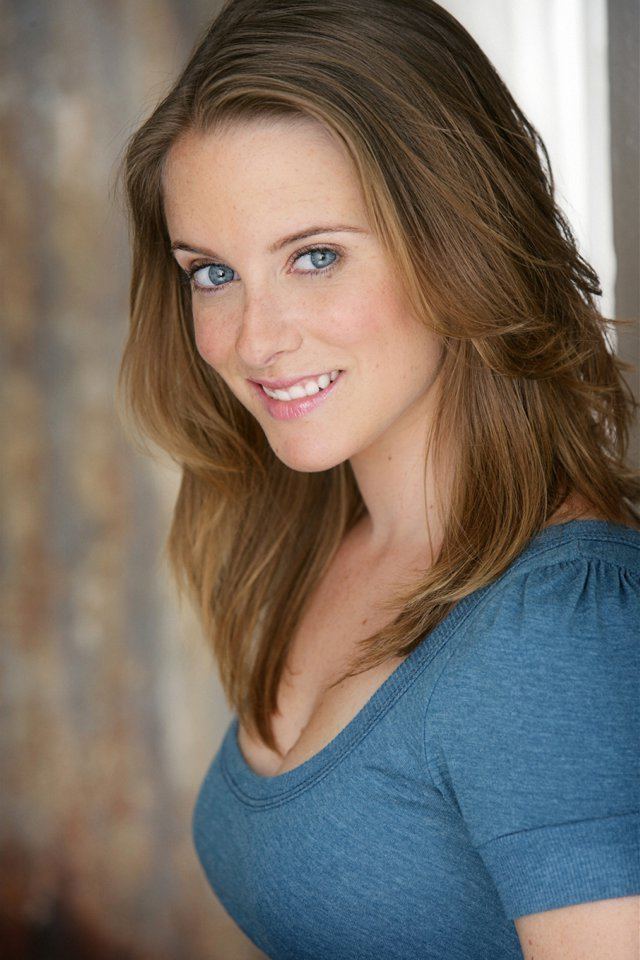 Marley McClean smiling with blue eyes while wearing a blue blouse