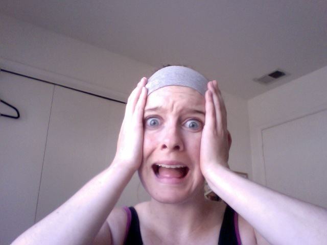 Marley McClean with a shocked face while wearing a gray headband and black sleeveless top