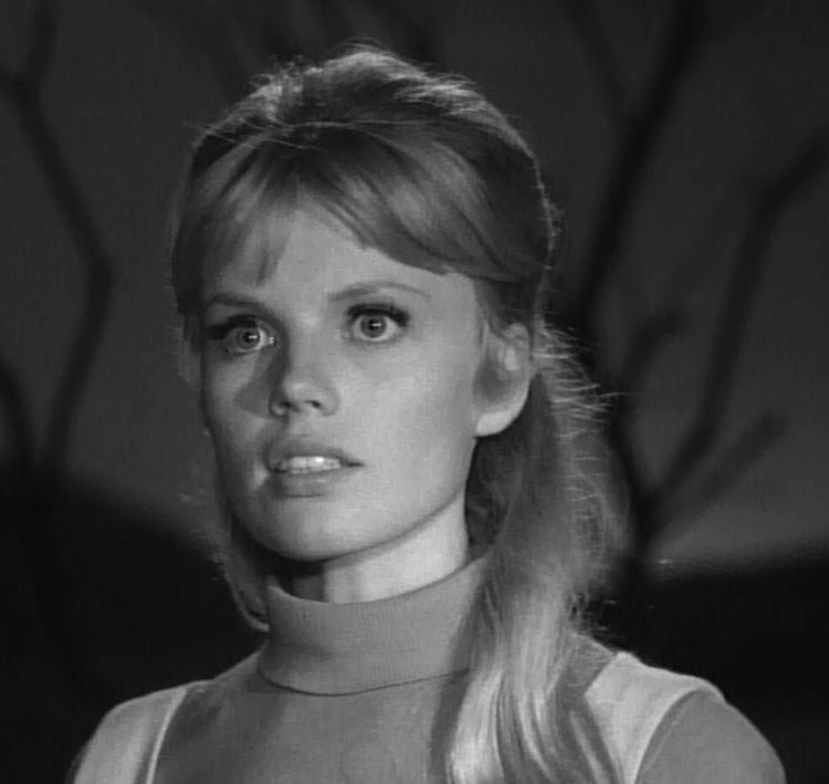 Marta Kristen as Judy Robinson with blonde hair in a movie scene from Lost in Space, an American science fiction television series.