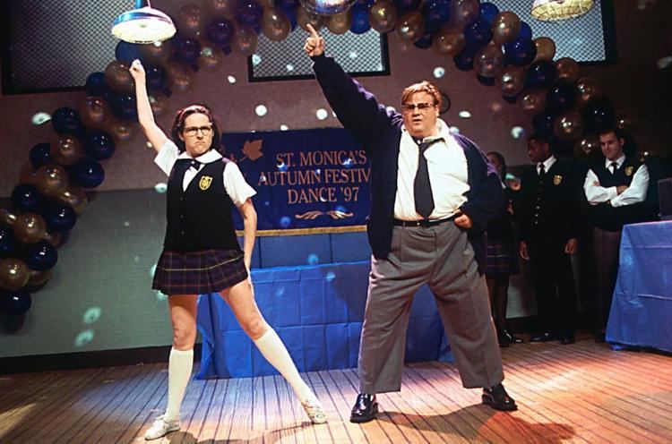 Mary Katherine Gallagher (left) is serious, has black hair, her left hand behind her legs, right hand up, behind on left are her schoolmates, during the St. Monicas Autumn Festival Dance with blue and gold balloons, blue banner, and table, she is wearing an eyeglass, white school uniform under a black vest with the school patch, a dark-blue bow tie, a red headband, plaid skirt, white knee socks, and white shoes. Matthew Foley (right) is serious, mouth half opened, has brown hair, right hand up, left hand on his waist, during the St. Monicas Autumn Festival Dance with blue and gold balloons, he is wearing black shades, white long sleeves, black necktie, under a black jacket, gray pants, black belt, and black shoes.