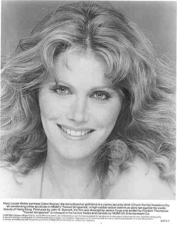 Mary Louise Weller is smiling, and has long blonde hair, below is a description “Mary Louise Weller portrays Claire Bonnor the school teacher girlfriend of a casino security chief (Chuck Norris) threatened by an unrelenting crime syndicate in MGM’s Forced Vengeance, a high caliber action-adventure story set against the exotic beauty of Hongkong. Produced by John B. Bonnett, the film was directed by James Fargo and written by Franklin Thompson “Forced Vengeance” is released in the United States and Canada by MGMUA Entertainment Co. She is wearing a white top.