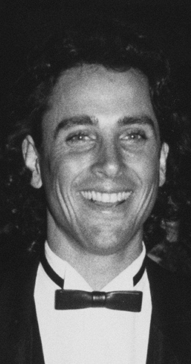 Matt Lattanzi smiling while wearing black coat, white long sleeves and bow tie