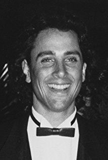 Matt Lattanzi smiling while wearing black coat, white long sleeves and bow tie