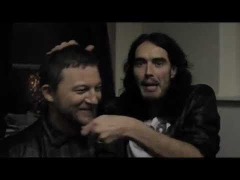 Matt Morgan smiling while Russell Brand holding his face