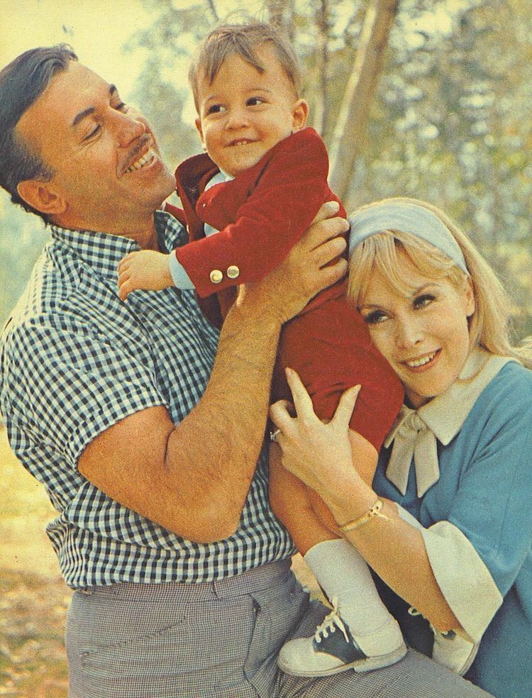 Michael Ansara and Barbara Eden carrying their baby, Matthew Ansara