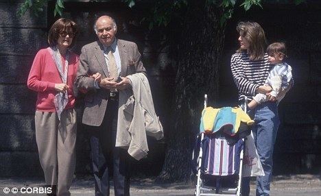 Jacqueline Kennedy Onassis walking with her boyfriend Maurice Templesman and Caroline while carrying her son