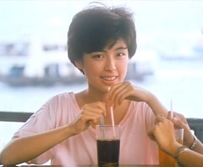 May Lo smiling and with short hair while drinking soda.