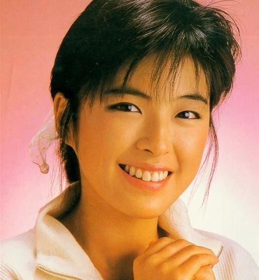 May Lo with a smiling face and wearing a white polo shirt.