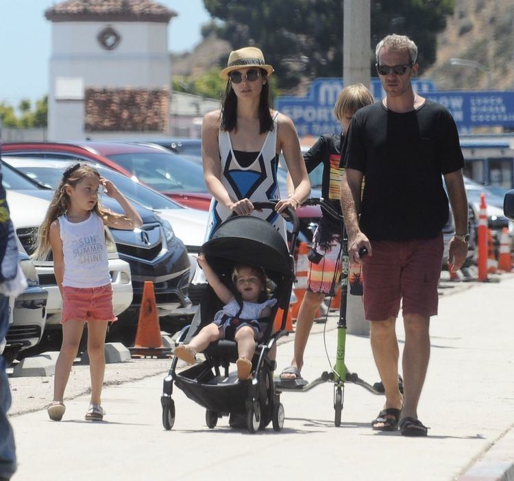 Maya Versano riding in a stroller being pushed by her mom together with her Dad and elder sister Alma