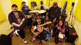 Nikki Tirona, Shan Regalado, Carlo Servano, Monty Macalino, and Maan Furio of the Mayonnaise band smiling together while at the studio
