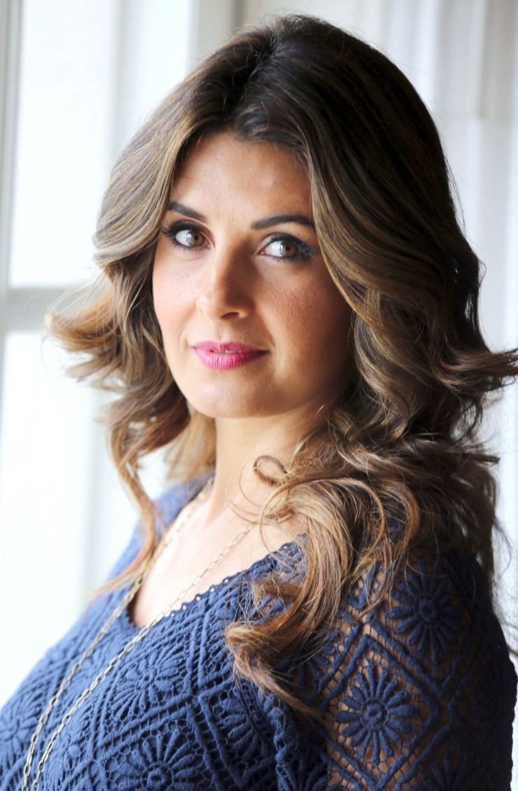 Mayrín Villanueva smiling and wearing blue blouse