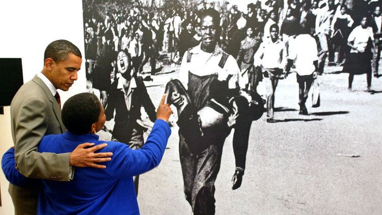 Barack Obama looking at the iconic photo at the Hector Pieterson Museum, Soweto, with Hector’s sister