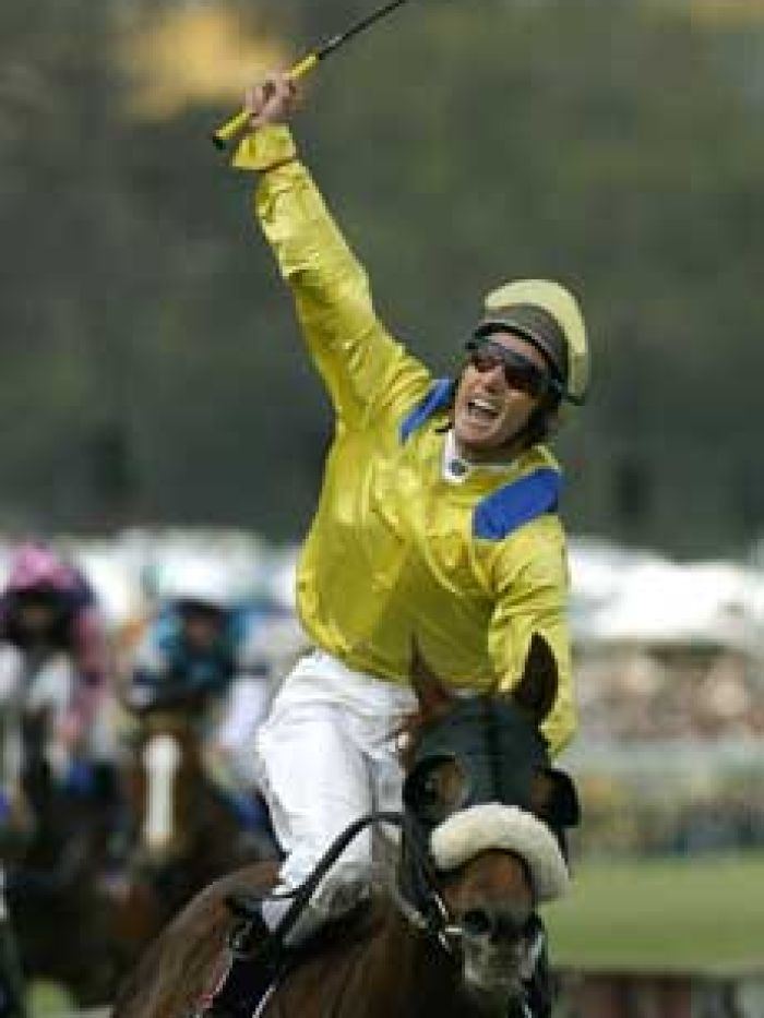 Media Puzzle Damien Oliver celebrates on Media Puzzle after winning the 2002