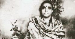 A younger Meenakshi Sundaram Pillai standing with a Bindi on the forehead and wearing religious robes.