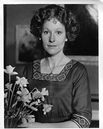 Meg Wynn Owen holding a flower in black and white