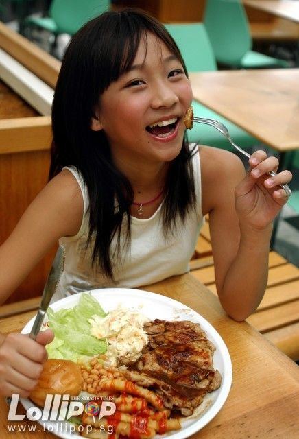 Megan Zheng wearing a white sando while eating