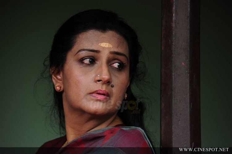 Menaka (actress) on her sad face wearing a dress and pair of earrings